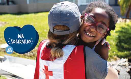 Red Cross volunteer hugging a young girl