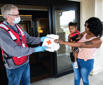 Volunteer holds up baby