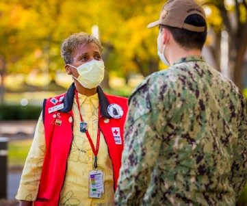 red cross nurse helps patient