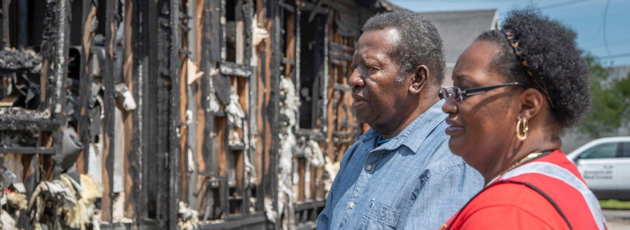 Family looks at fire damaged home