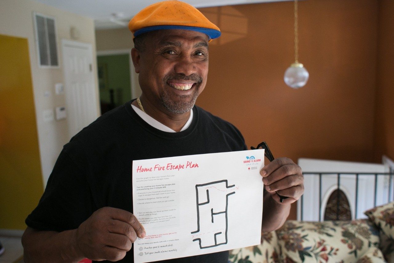 Man Holding Home Fire Escape Plan Handout