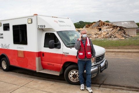 Red Cross volunteer on the phone outside of Disaster Relief van