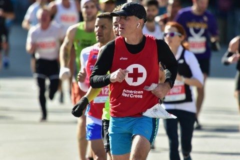 A man runs a race to raise money for the Red Cross