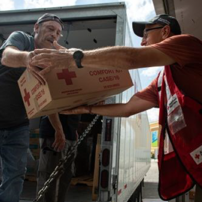 Red Cross volunteer loading supplies into the truck.