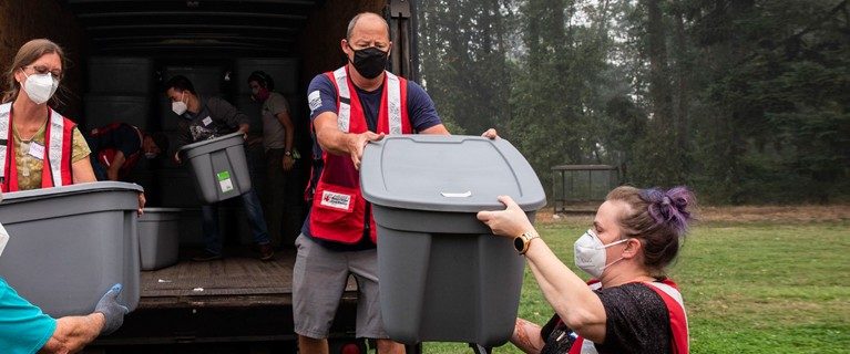 Red Cross volunteers carrying supplies