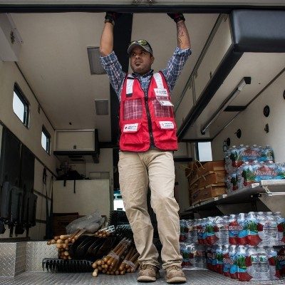 A Red Cross volunteer in the back of a disaster supply van