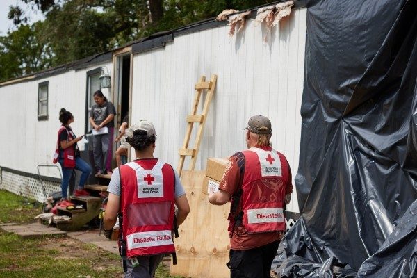 Red Cross volunteers visit a local family after a disaster