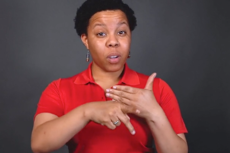 A woman explains fire safety using sign language