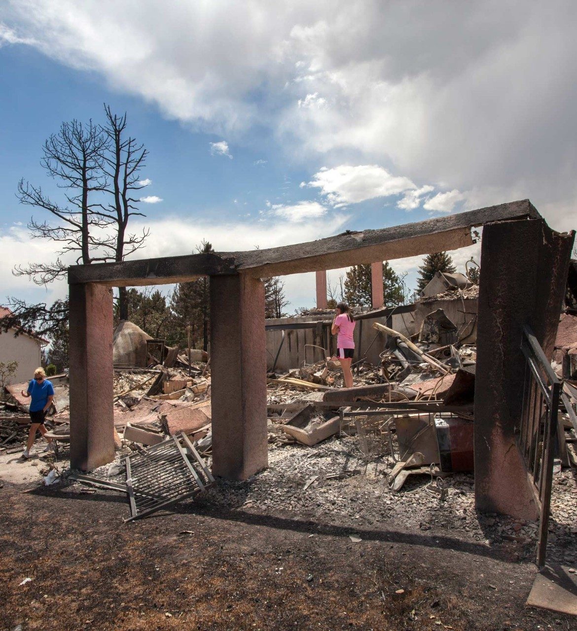 A family walks through their home after a fire