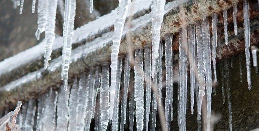 Icicles hanging from an exposed pipe