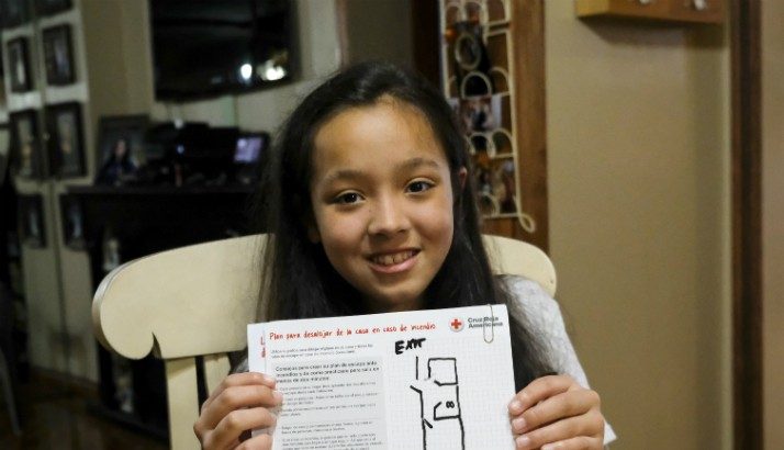 A girl shows the home fire escape plan she just made