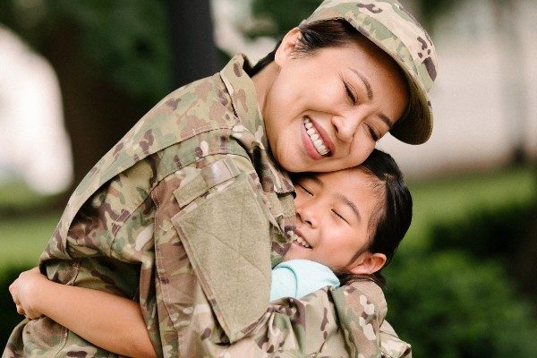 Female soldier hugs her daughter