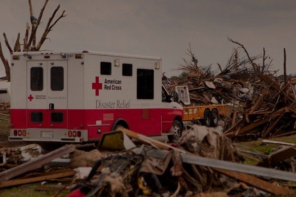 A Red Cross vehicle brings supplies to a neighborhood hit by a tornado