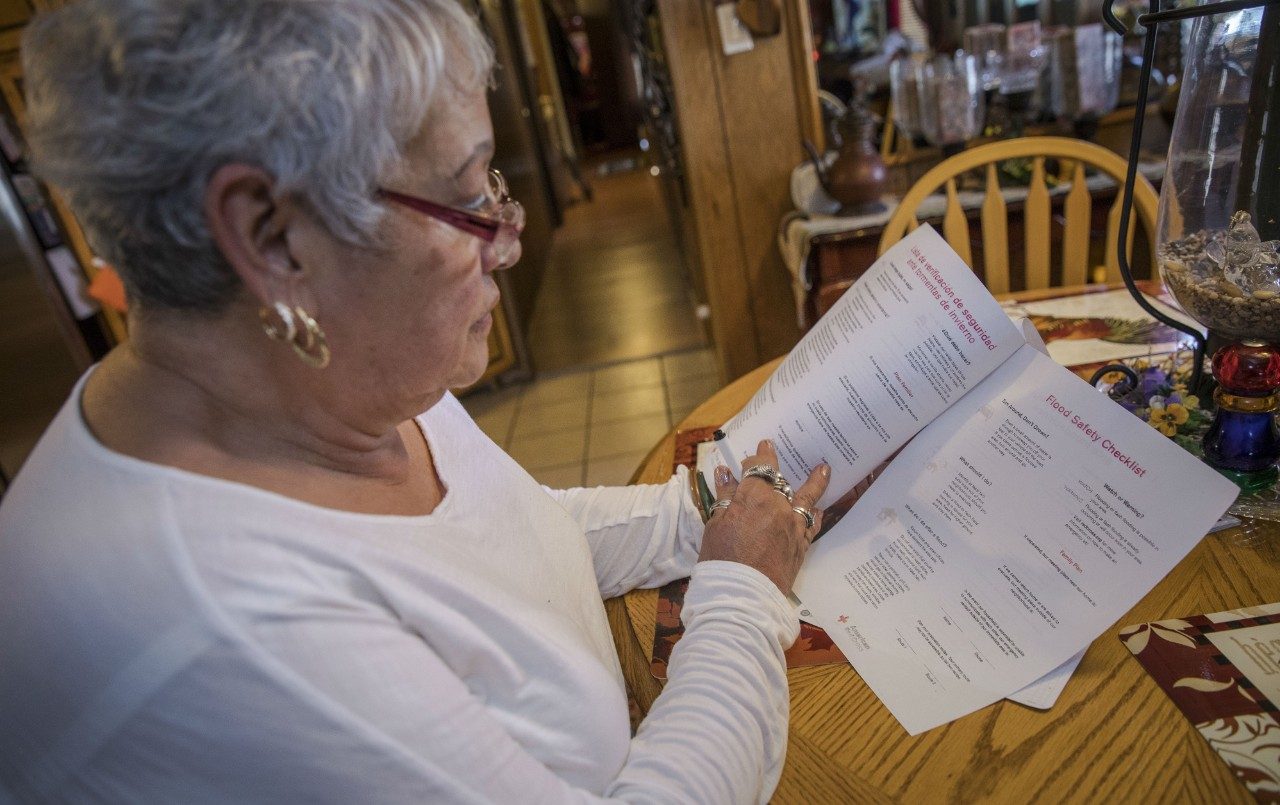 Woman reviews safety information at home