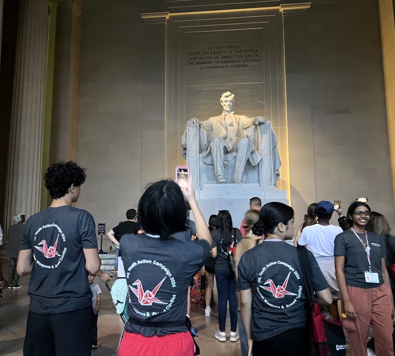 youth action campaign members in matching shirts taking pictures at the Lincoln Memorial in Washington, DC