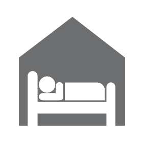 A person laying in bed at a shelter icon