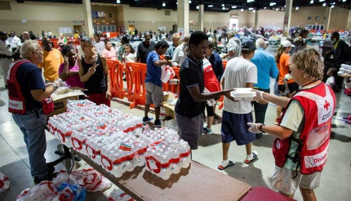 Volunteers hand out meals