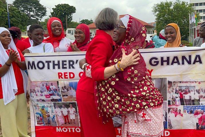 In Ghana, Kate Forbes hugs one of the women in the Mother’s Club