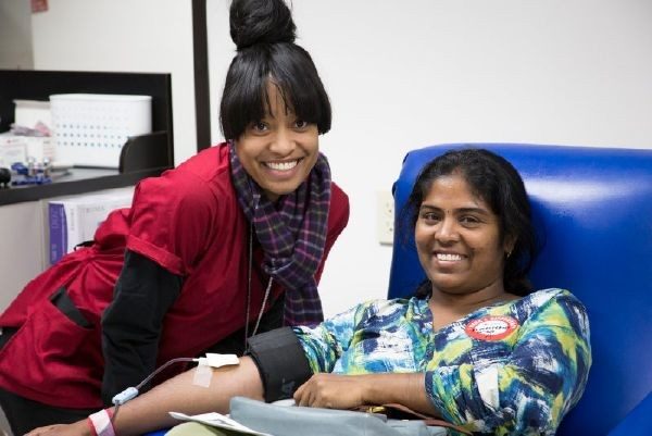 woman happily donating blood
