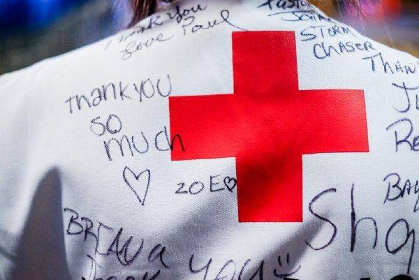 Rear view of a Red Cross vest with thank you written on it.