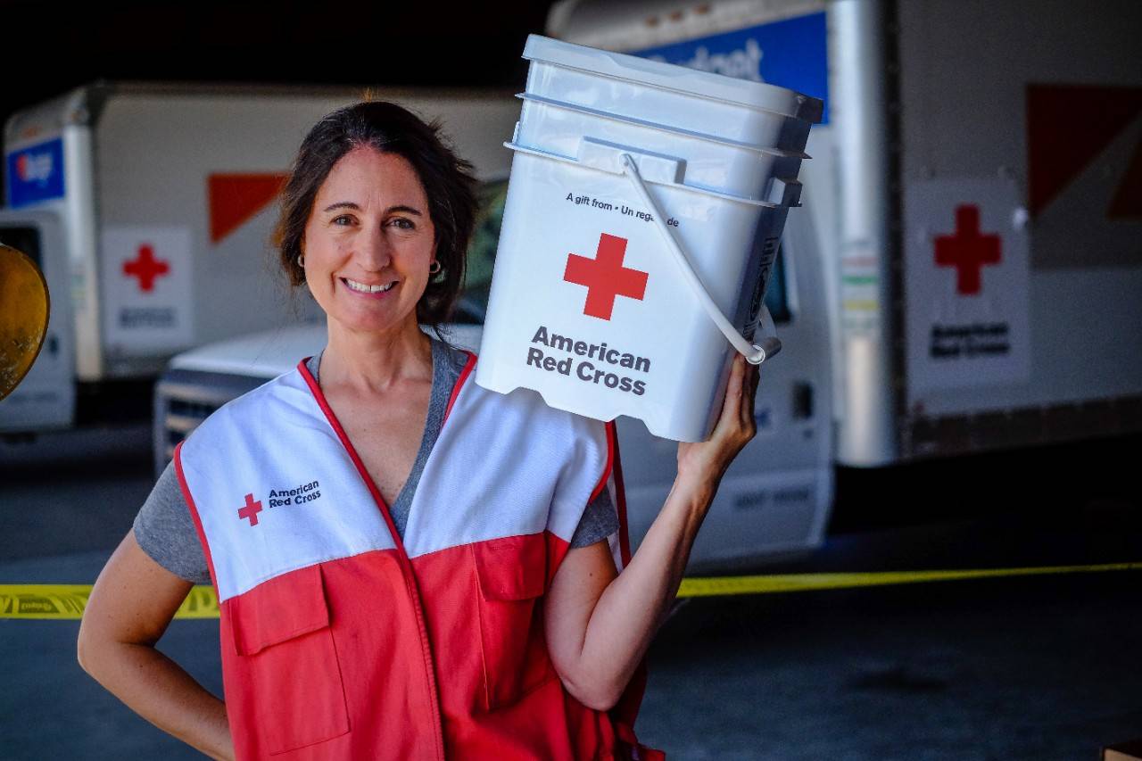 September 9, 2017. Houston, Texas. Red Cross volunteer Julie  on her first deployment working with Distribution of Emergency Supplies Group shows off the back of her Red Cross vest that children signed with messages thanking the Red Cross for helping their families recover from Hurricane Harvey. “It just put a smile on their faces,” she said adding that it was great to work with volunteers who step up to what needs to be done. Photo by Chuck Haupt for the American Red Cross