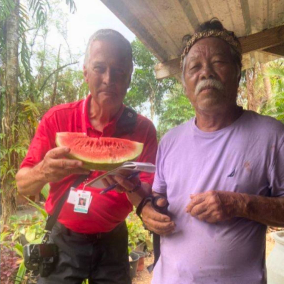 Volunteer, Kim Mailes with resident eating watermelon