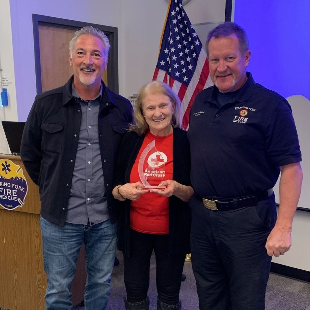 Rheta Fulton standing with 2 men at pitkin county sheriff office
