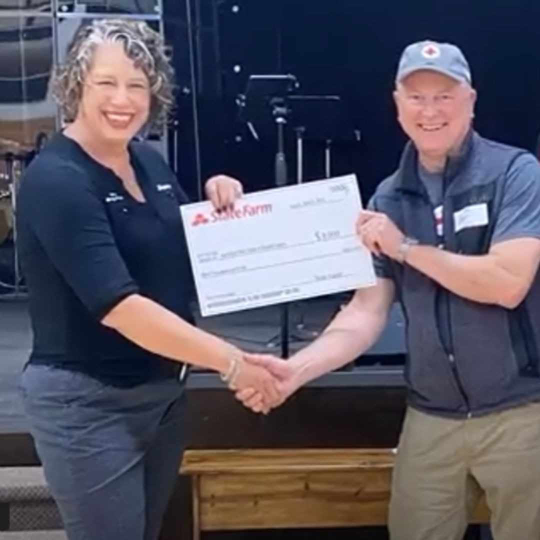 volunteers smiling with state farm check