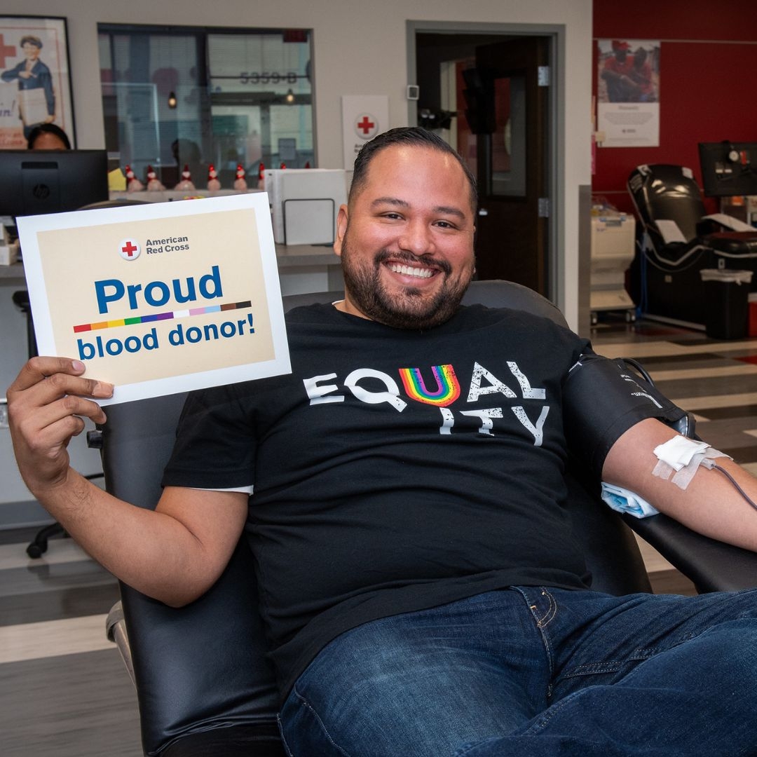 blood donor ralph gavan holding proud donor signage