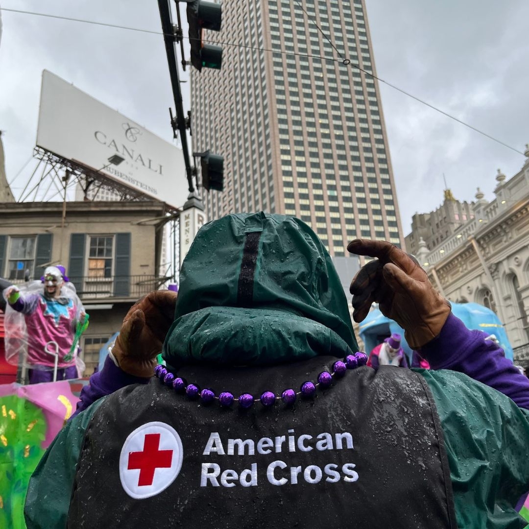 red crosser with mardi gras beads downtown