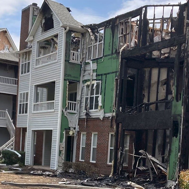 3 story apartment building damaged from fire.