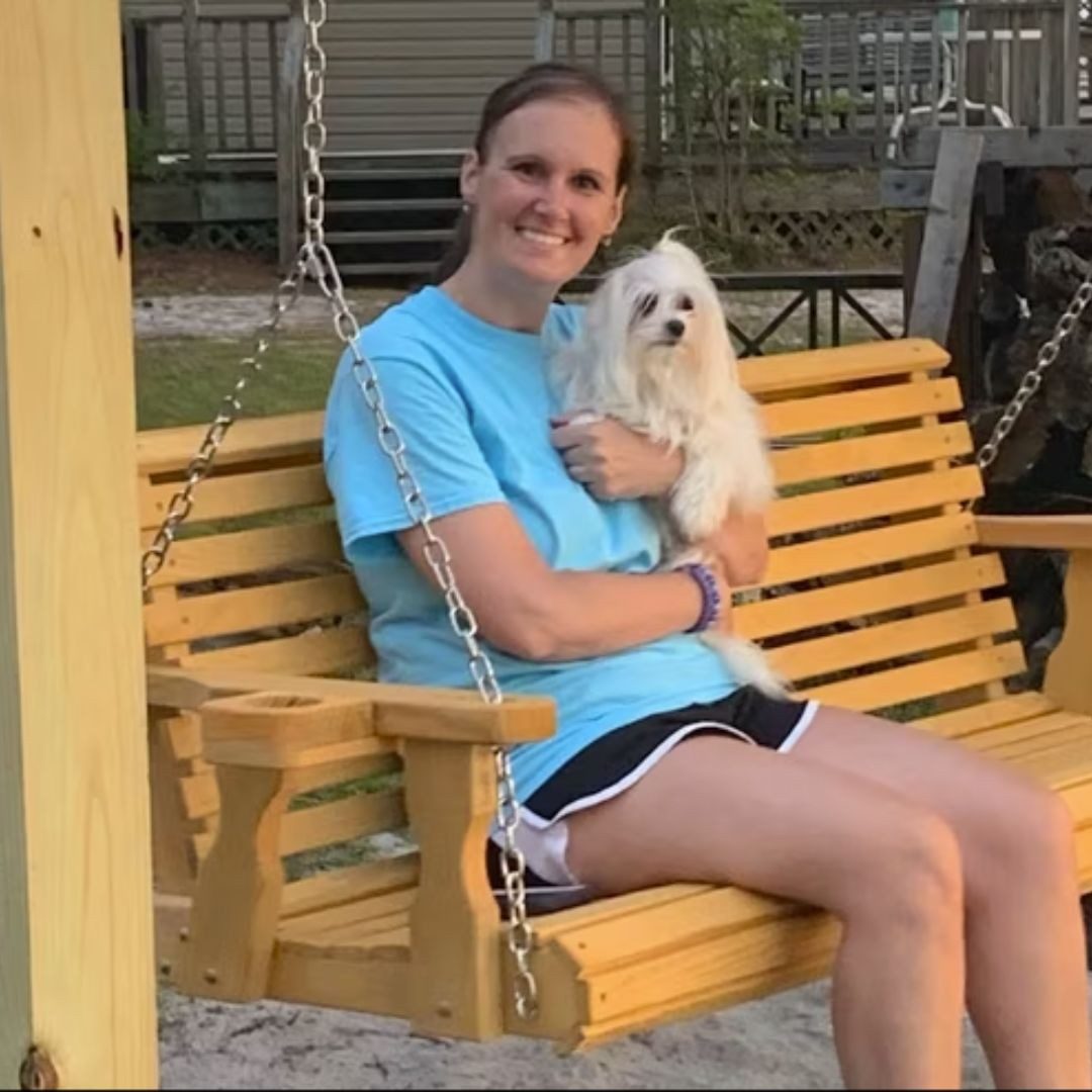 patricia and michael's daughter holding her dog