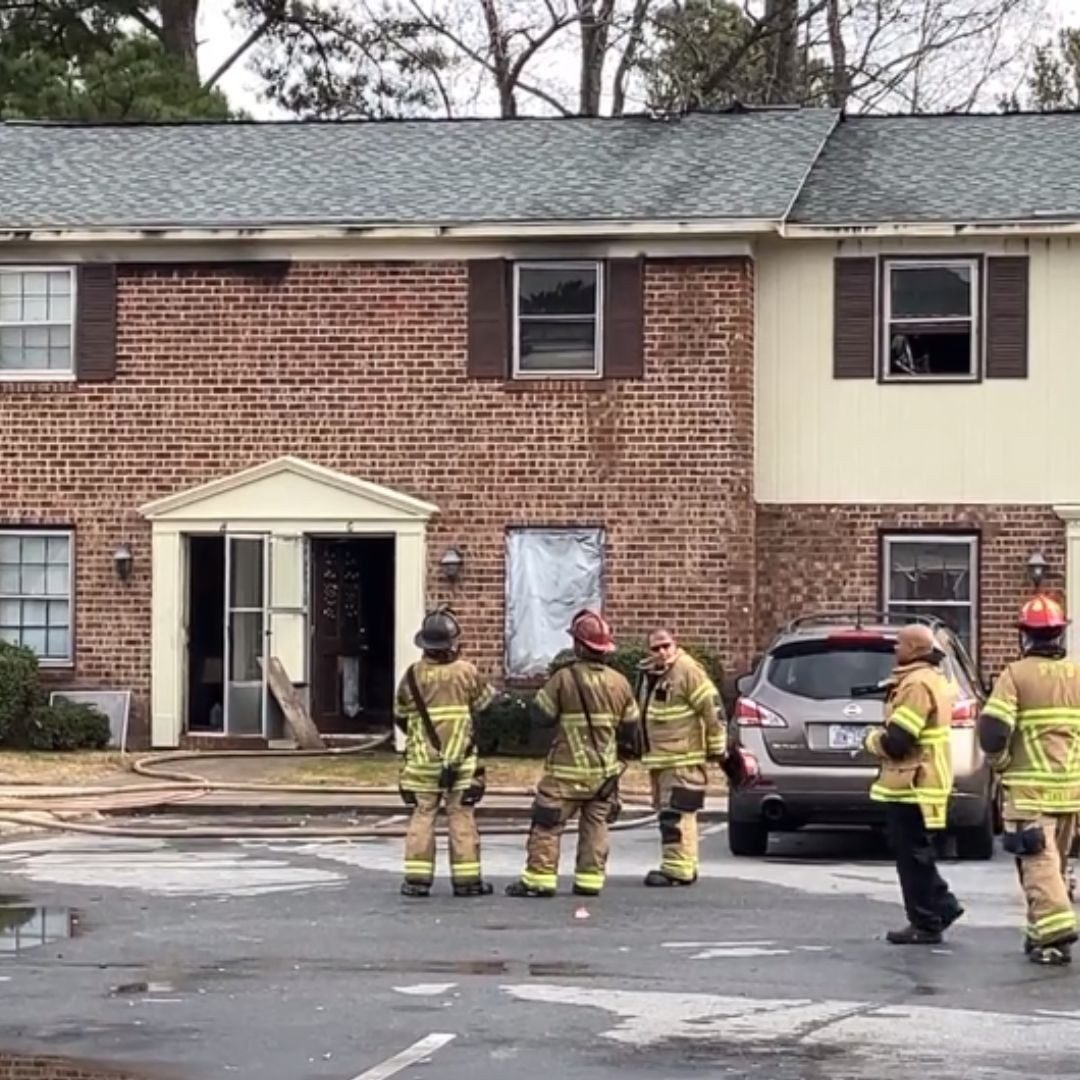 view of firefighters at scene of fire damage