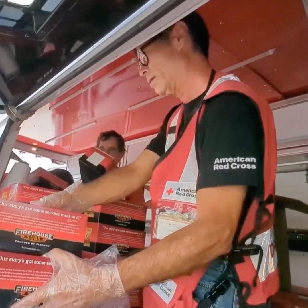 north florida volunteer handing out firehouse sub sandwiches