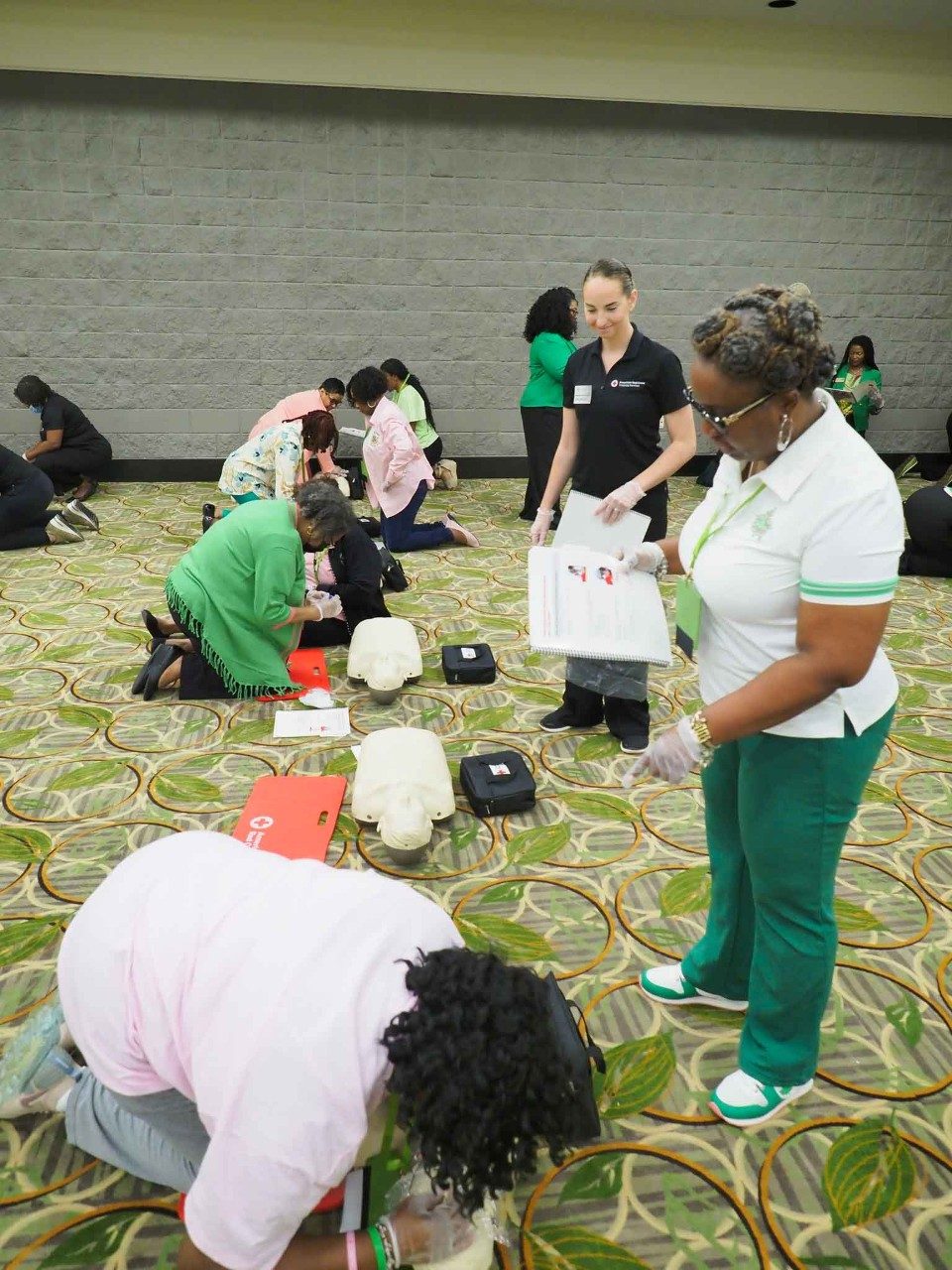 Volunteers teach Alpha Kappa Alpha Sorority, Inc., about CPR