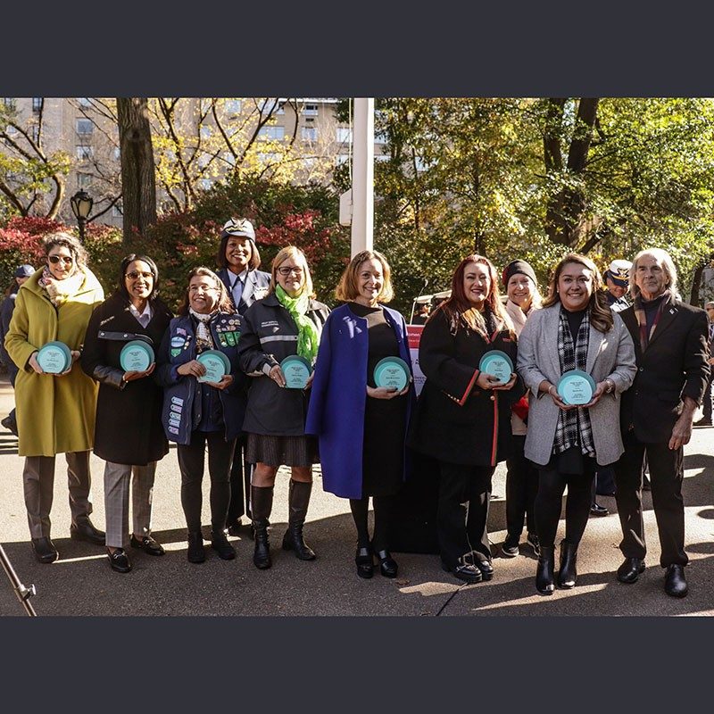 Group photo of women who serve America holding awards they received.