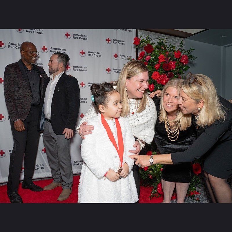 Red Cross Heroes Gala award winners, Juan Dilone and his daughter being congratulated.