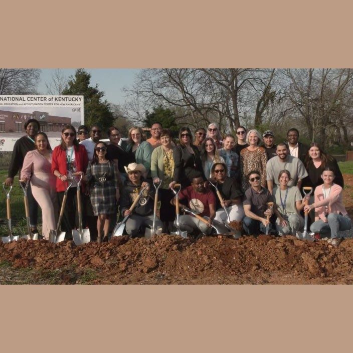 Large group of people with shovels at a ground breaking ceremony.