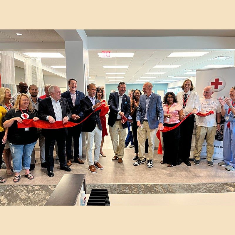 Group of Red Cross employees at ribbon cutting ceremony inside Louisville Blood Donor Center.