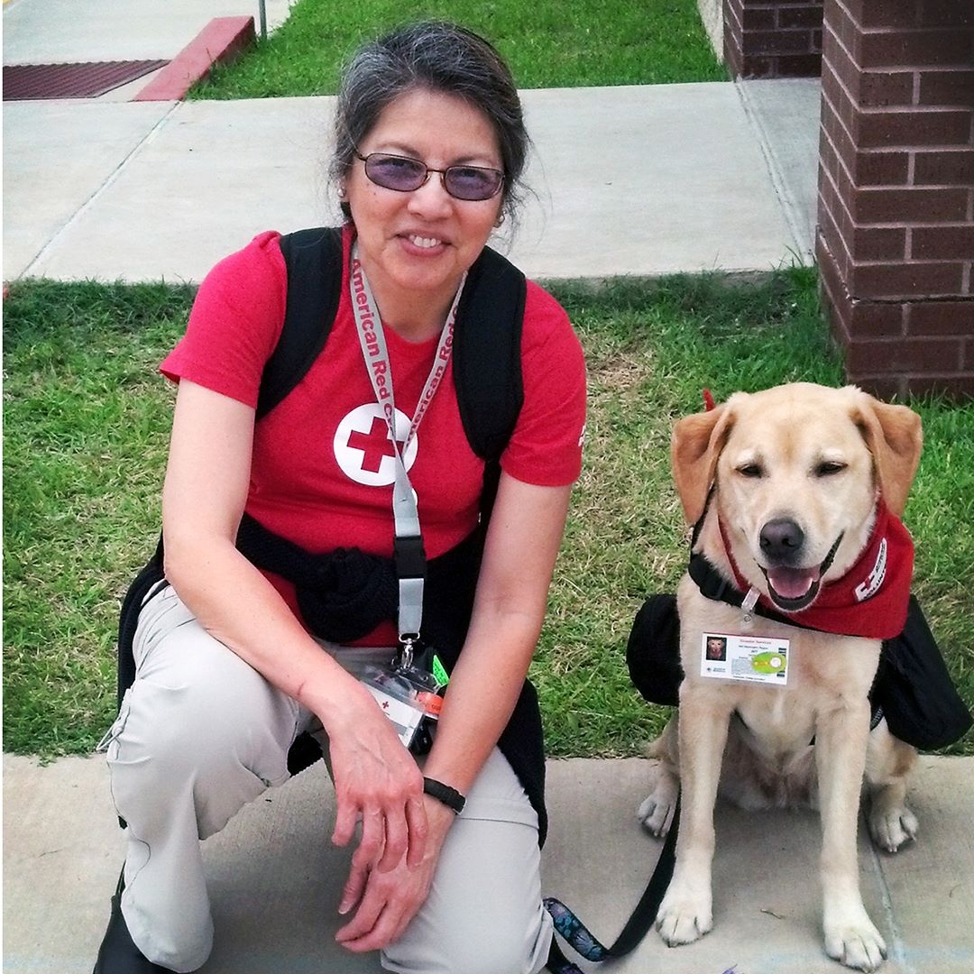 veteran volunteer carmela burke and dog pose for camera