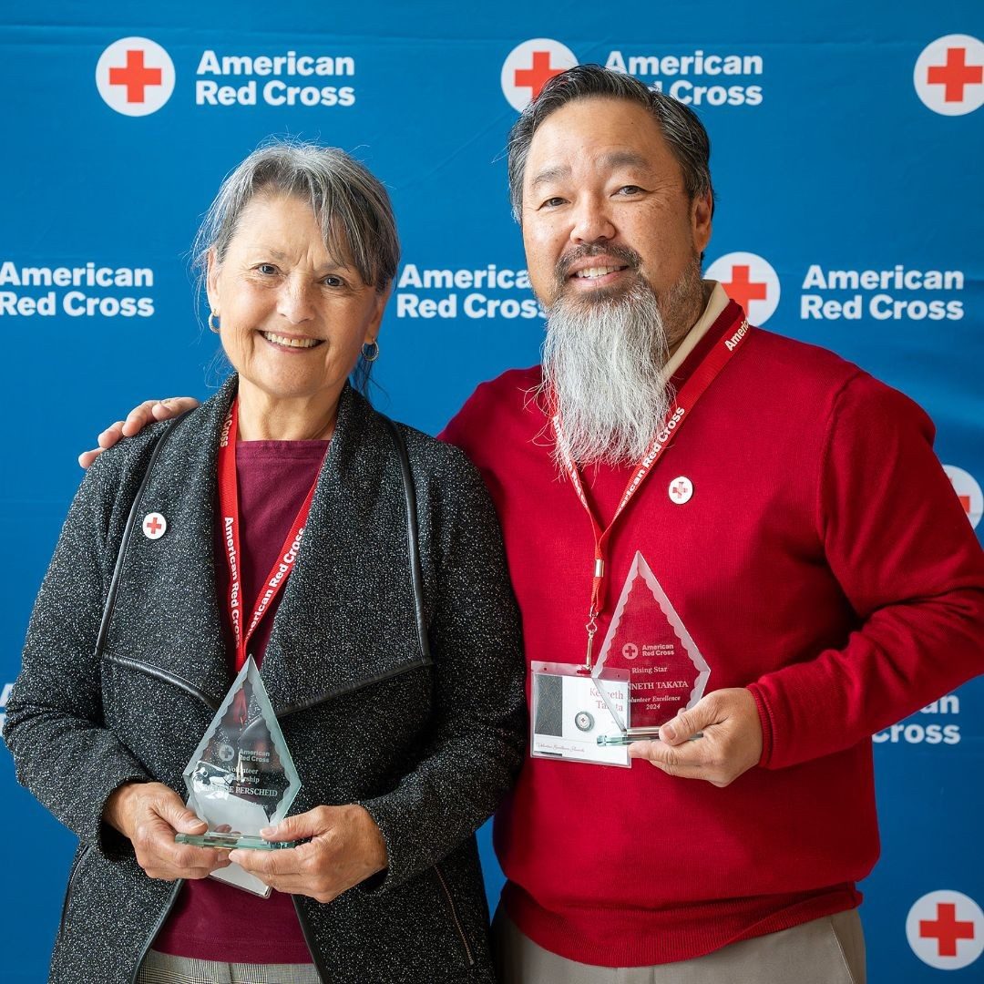 two redcrossers pose with awards