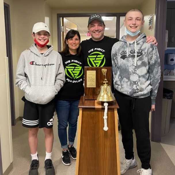 Dylan Fink with family and shaved head, smiles for pic.