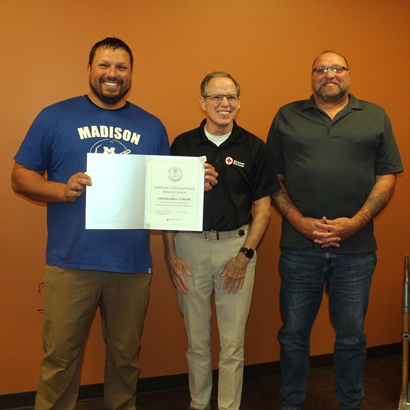 Chris Colarik holding the Lifesaving Award with, Red Cross Regional COO TIm O’toole, and Rich Colarik.