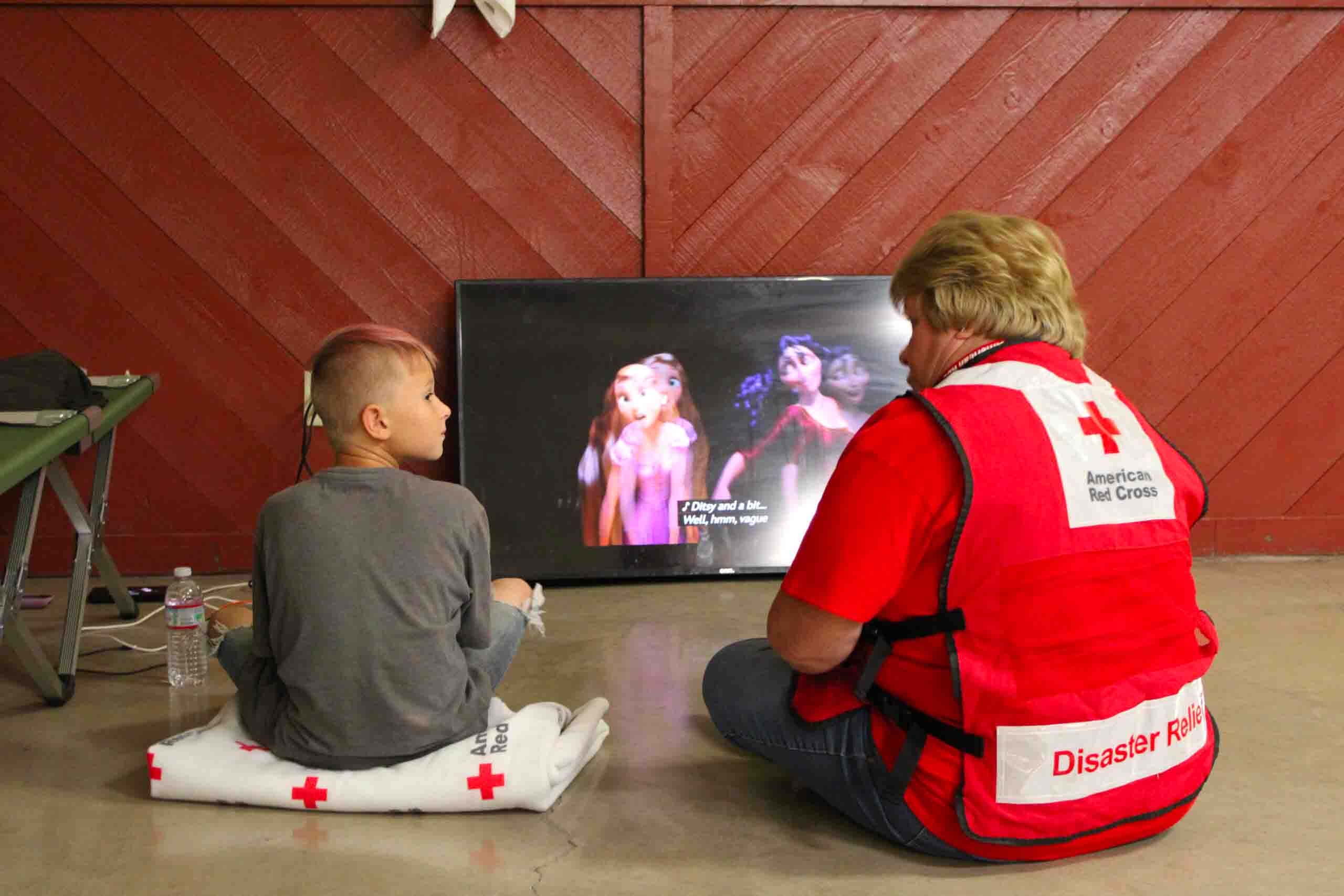 Volunteer with child during wildfires in Cascades