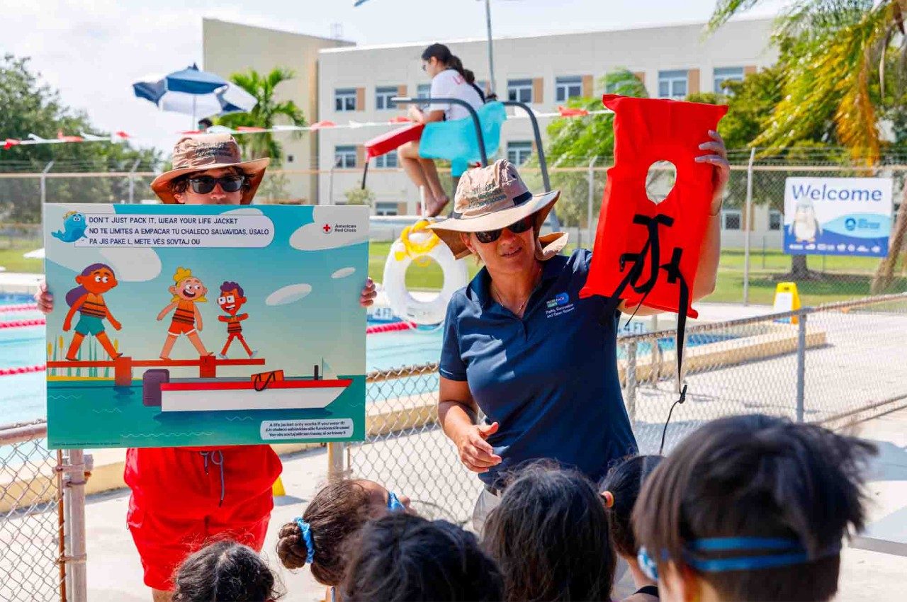 An instructor provides swim lessons in Miami