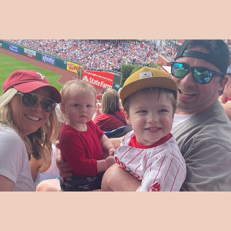 Brittany Berrodin with her husband Matthew and children Louie and Matilda in stands at a soccer game.