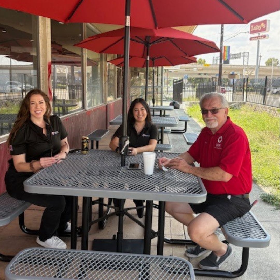 red crossers sitting at outside table