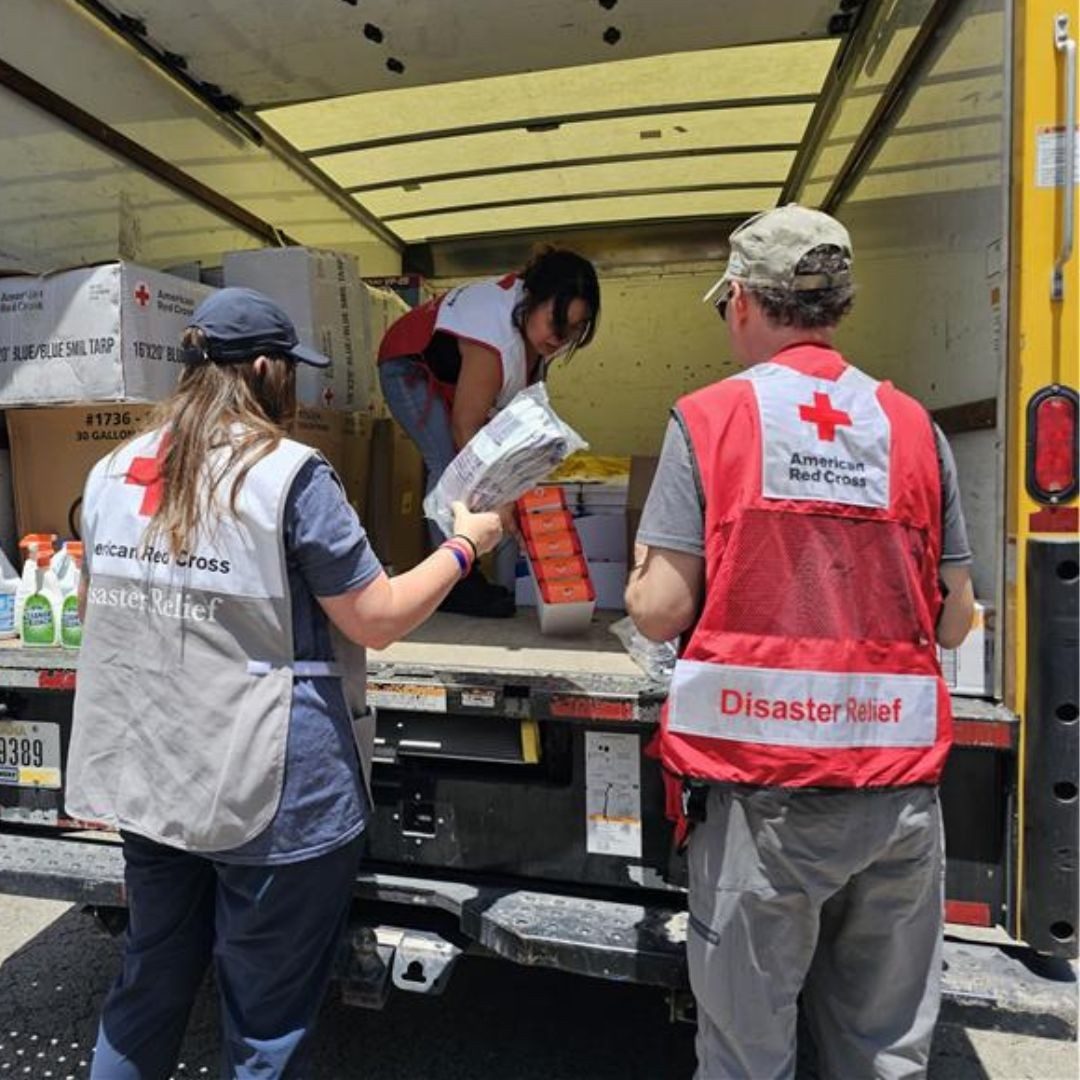 volunteers handing supplies outside of truck