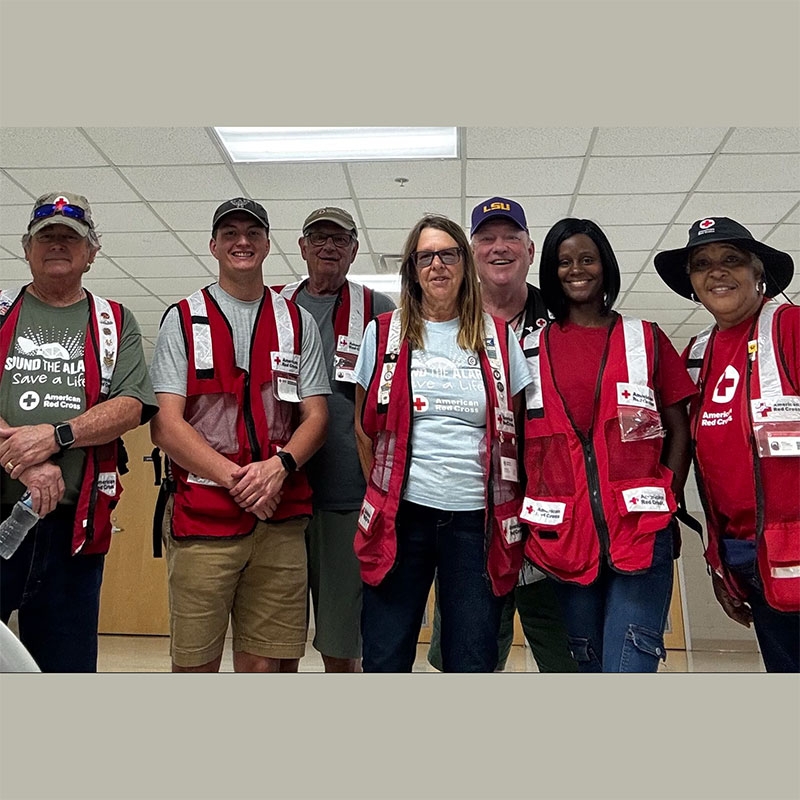 Group pic of seven Red Cross volunteers in an office building.