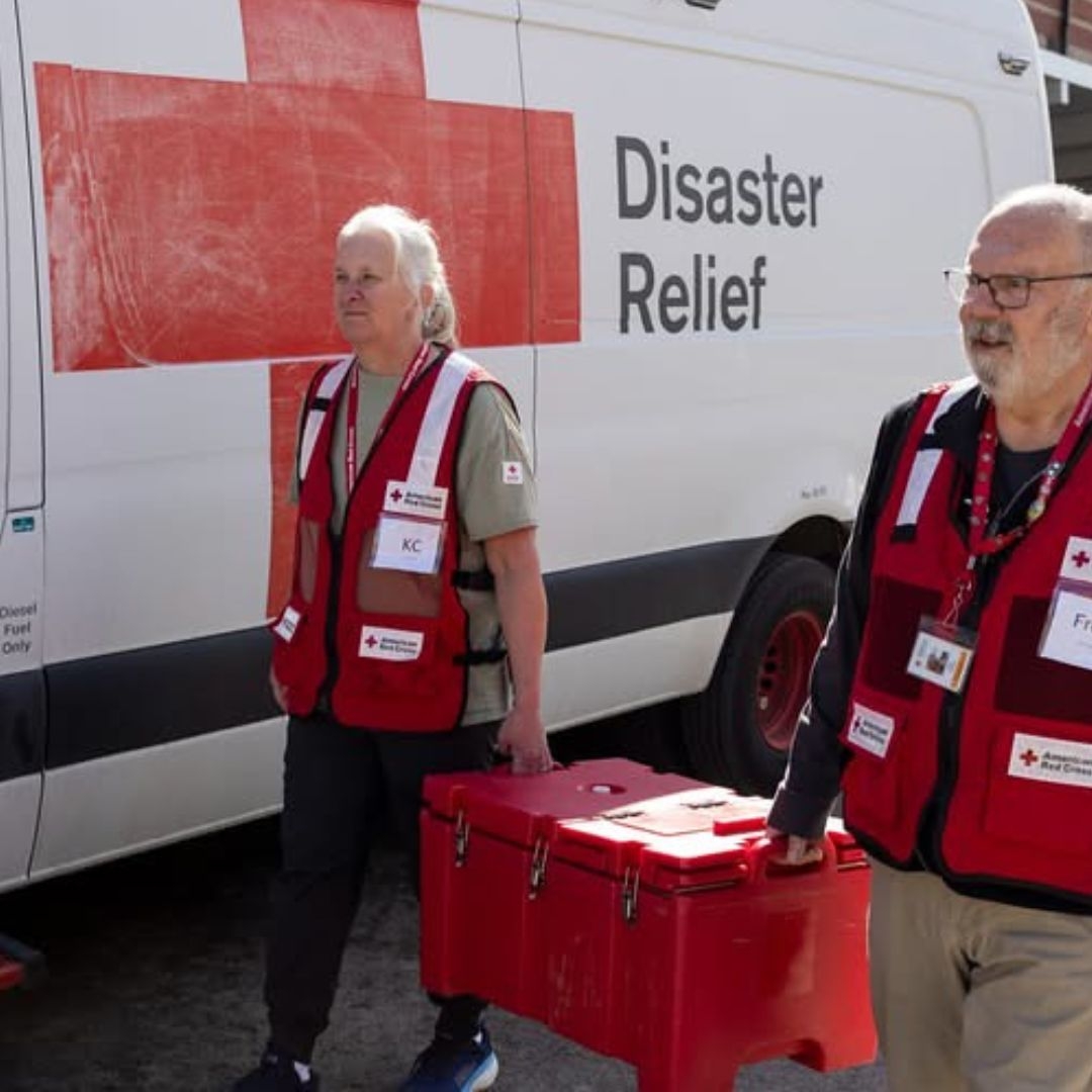 volunteers carrying boxes